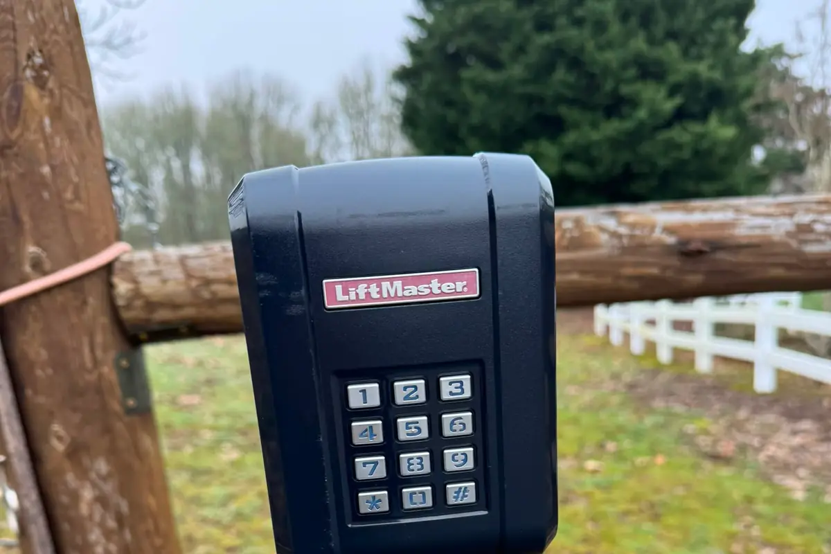 Closeup of LiftMaster wireless keypad mounted on post at country gate