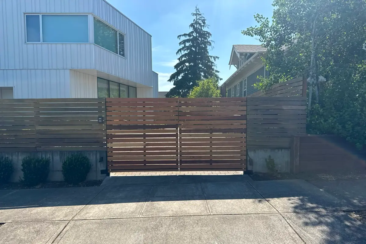 Modern horizontal cedar slat driveway gate with keypad, finished