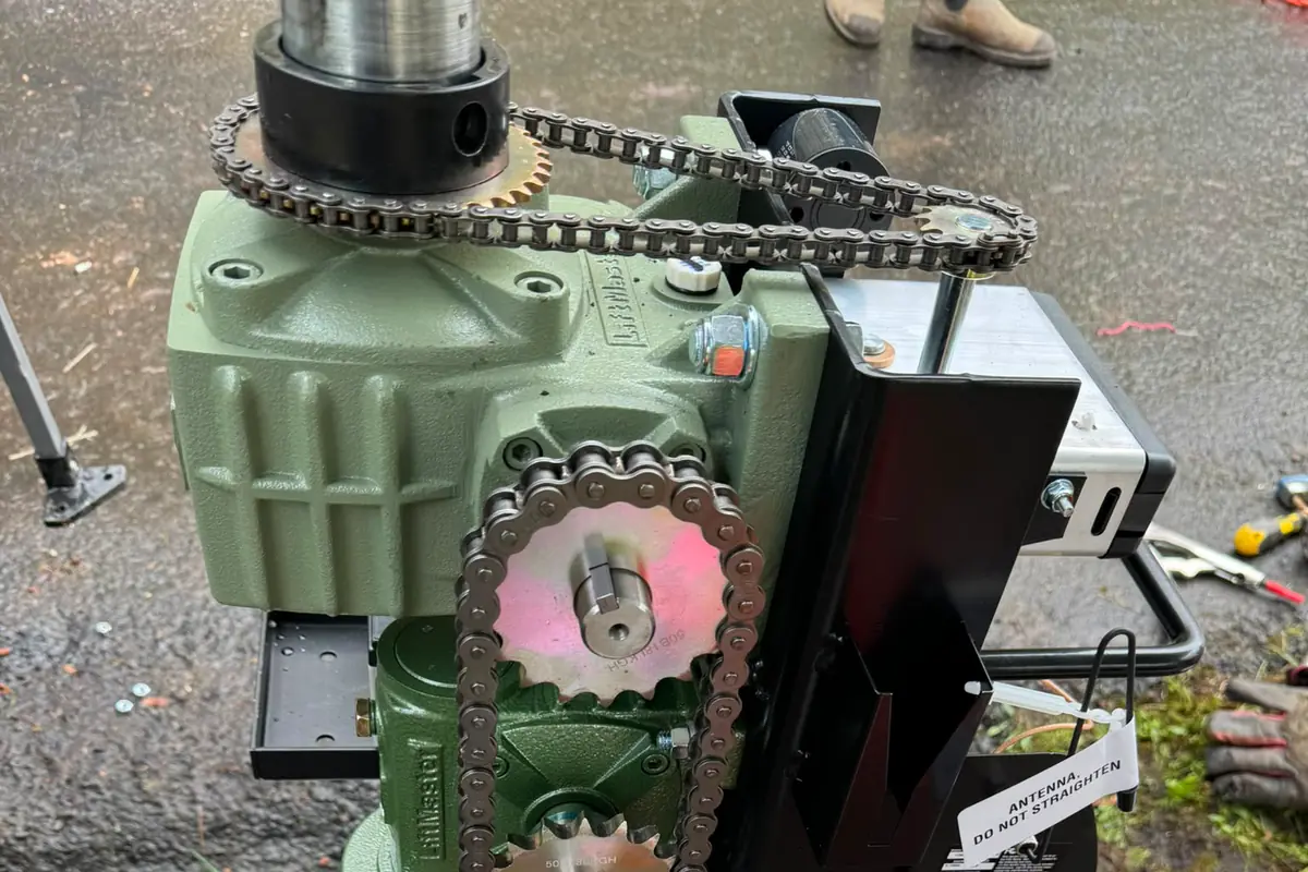 Close-up of LiftMaster green gearbox and chain sprockets on gate operator