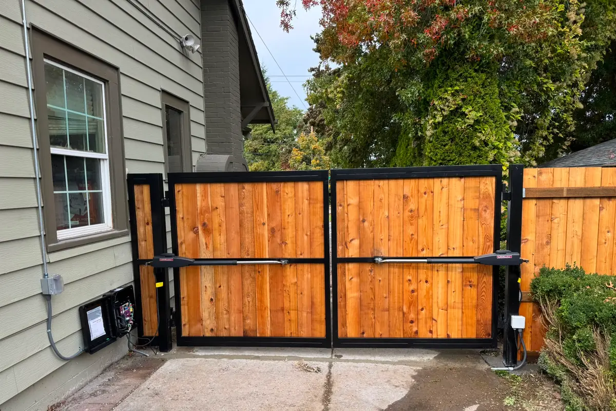 Automated cedar double swing gate with dual LiftMaster arm operators