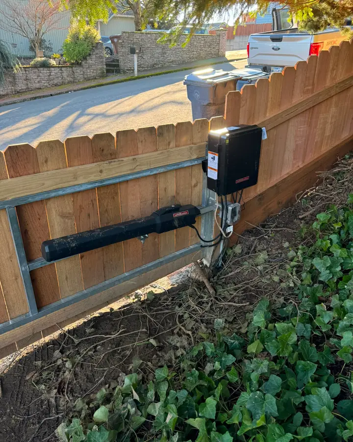 LiftMaster linear gate operator and control box mounted on cedar fence gate