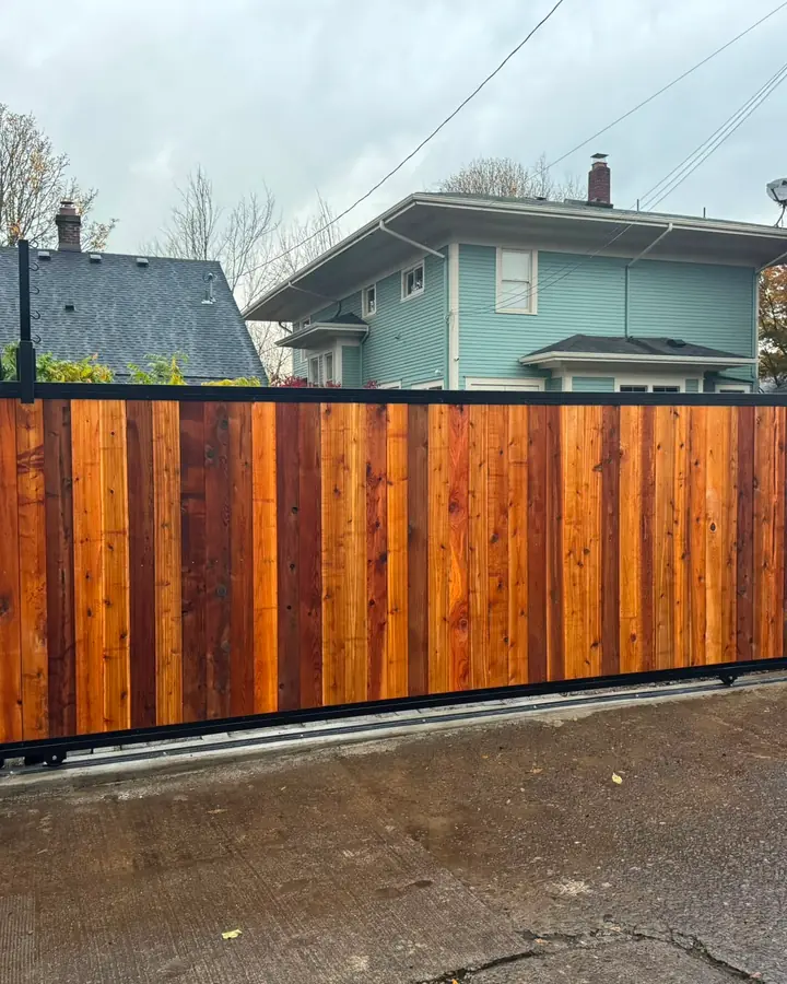 Completed cedar sliding driveway gate with keypad along residential alley — Interstate Gate Repair