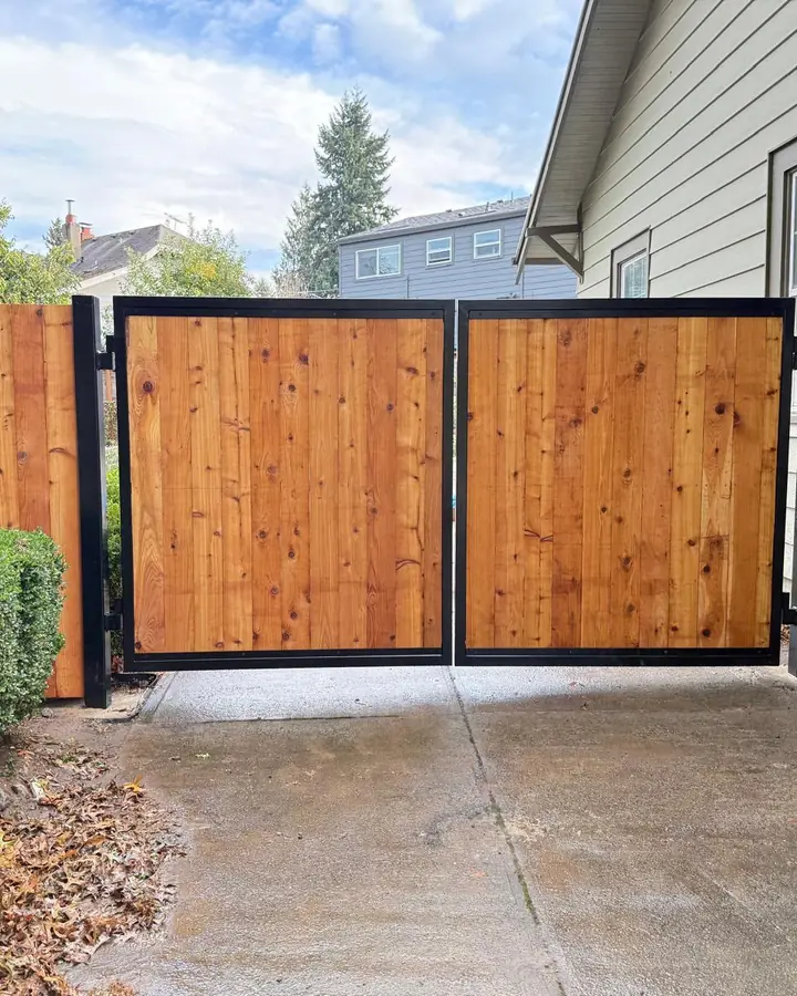 Cedar double swing driveway gate with fence wings in residential driveway — Interstate Gate Repair