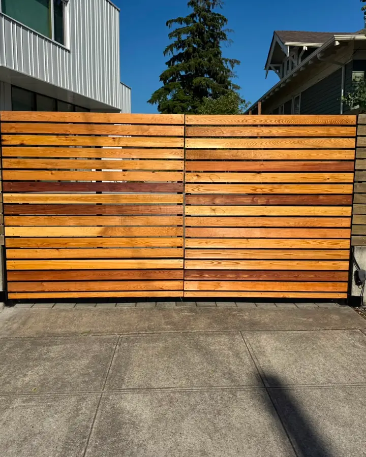Horizontal cedar slat automatic driveway gate with keypad, sunlit — Interstate Gate Repair